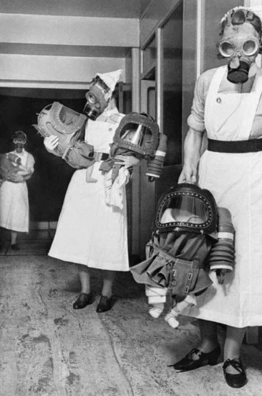 Gas-masked nurses and babies in England 